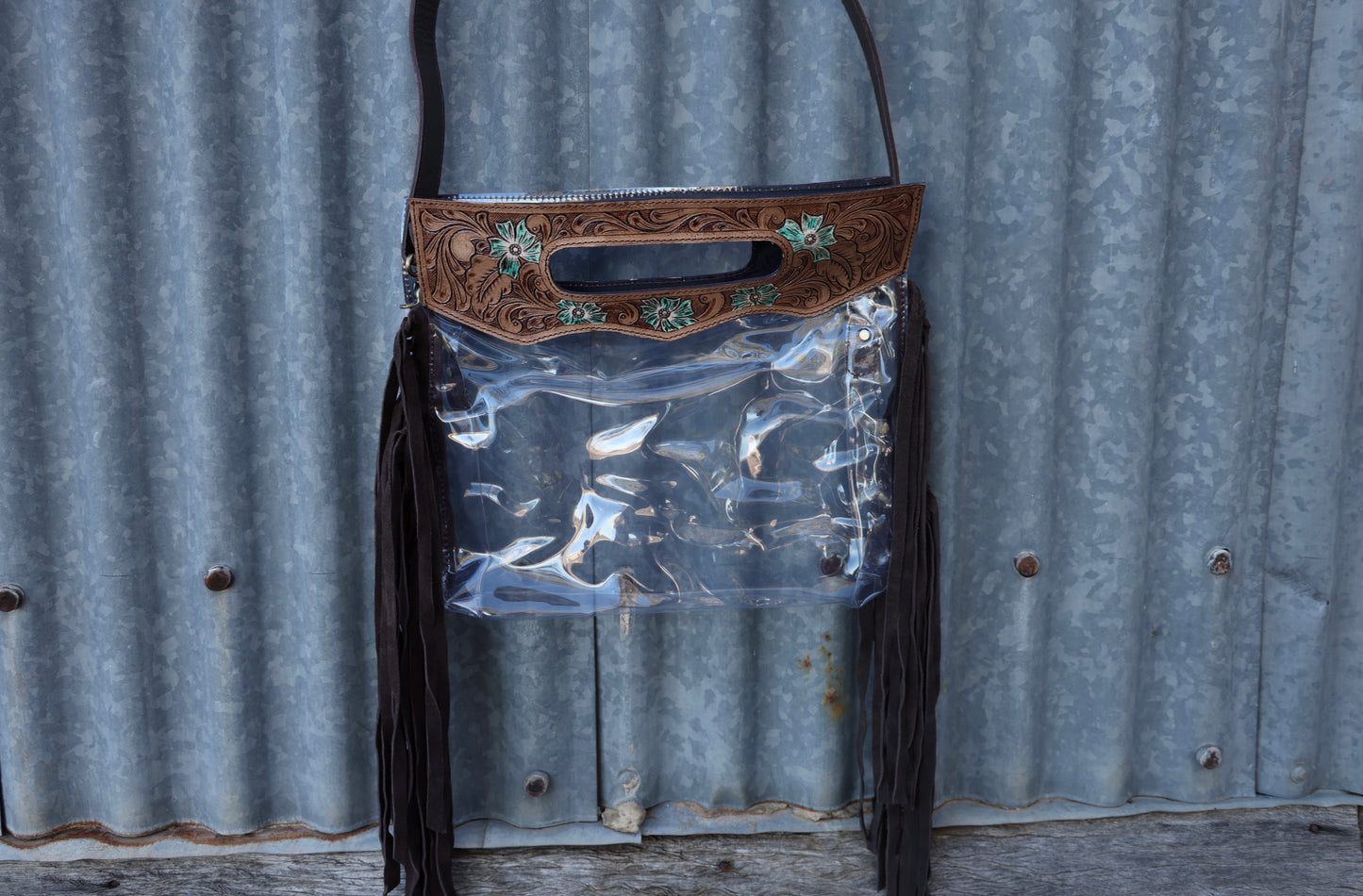 Clear pvc crossbody bag or clutch with hand tooled leather top handle with side fringe