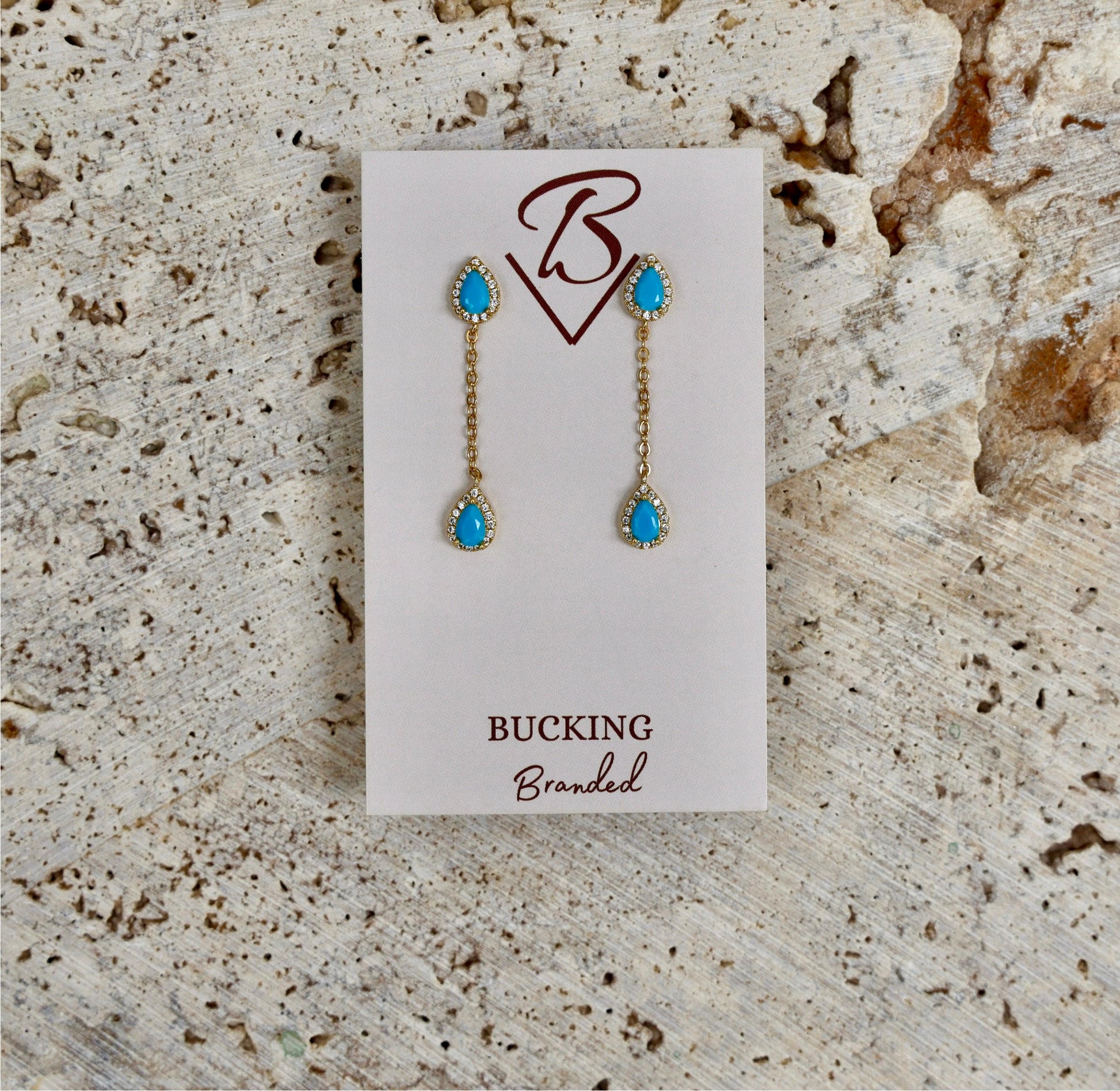 Stunning gold plated dangle earrings featuring Turquoise + Zircon stones.