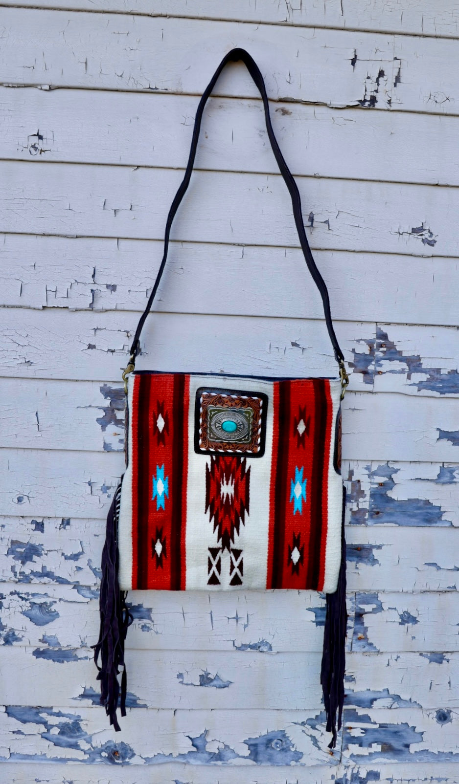 saddle blanket bag with side fridge and turquoise stone.