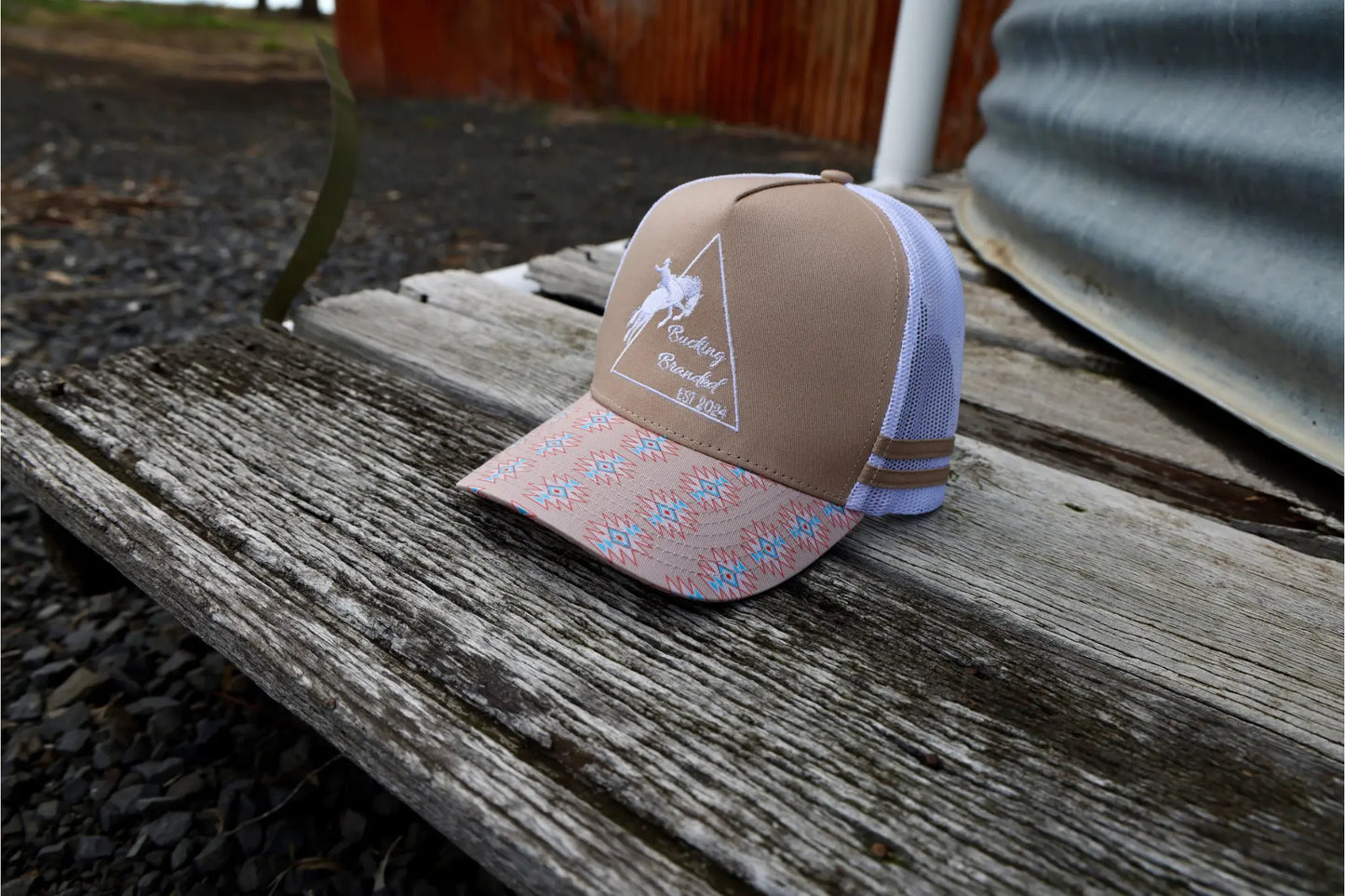 Cream Trucker Cap.
Embroidered original Bucking Branded logo on front panel.
Cream, blue & peach aztec pattern on and under brim.
White mesh & snapback.