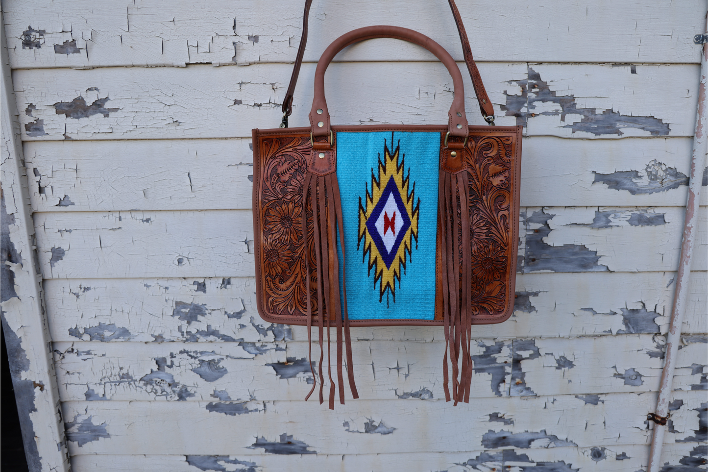 Hand tooled leather western bag with turquoise saddle blanket and fringe
