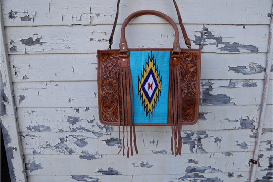 Hand tooled leather western bag with turquoise saddle blanket and fringe