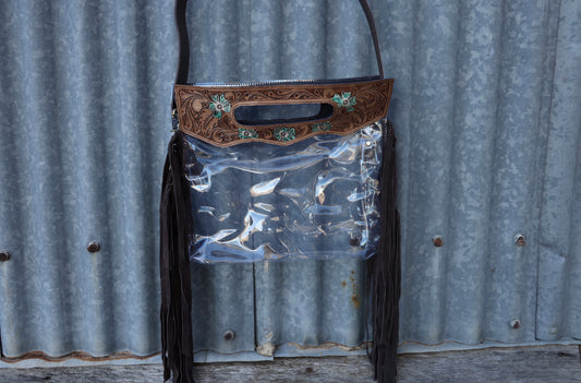 Clear pvc crossbody bag or clutch with hand tooled leather top handle with side fringe 