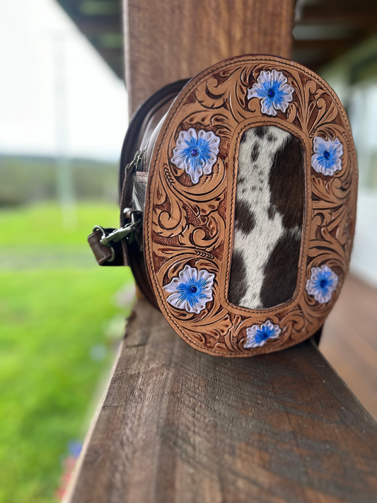 Hand tooled leather and cowhide oval bag. Hair on hide 